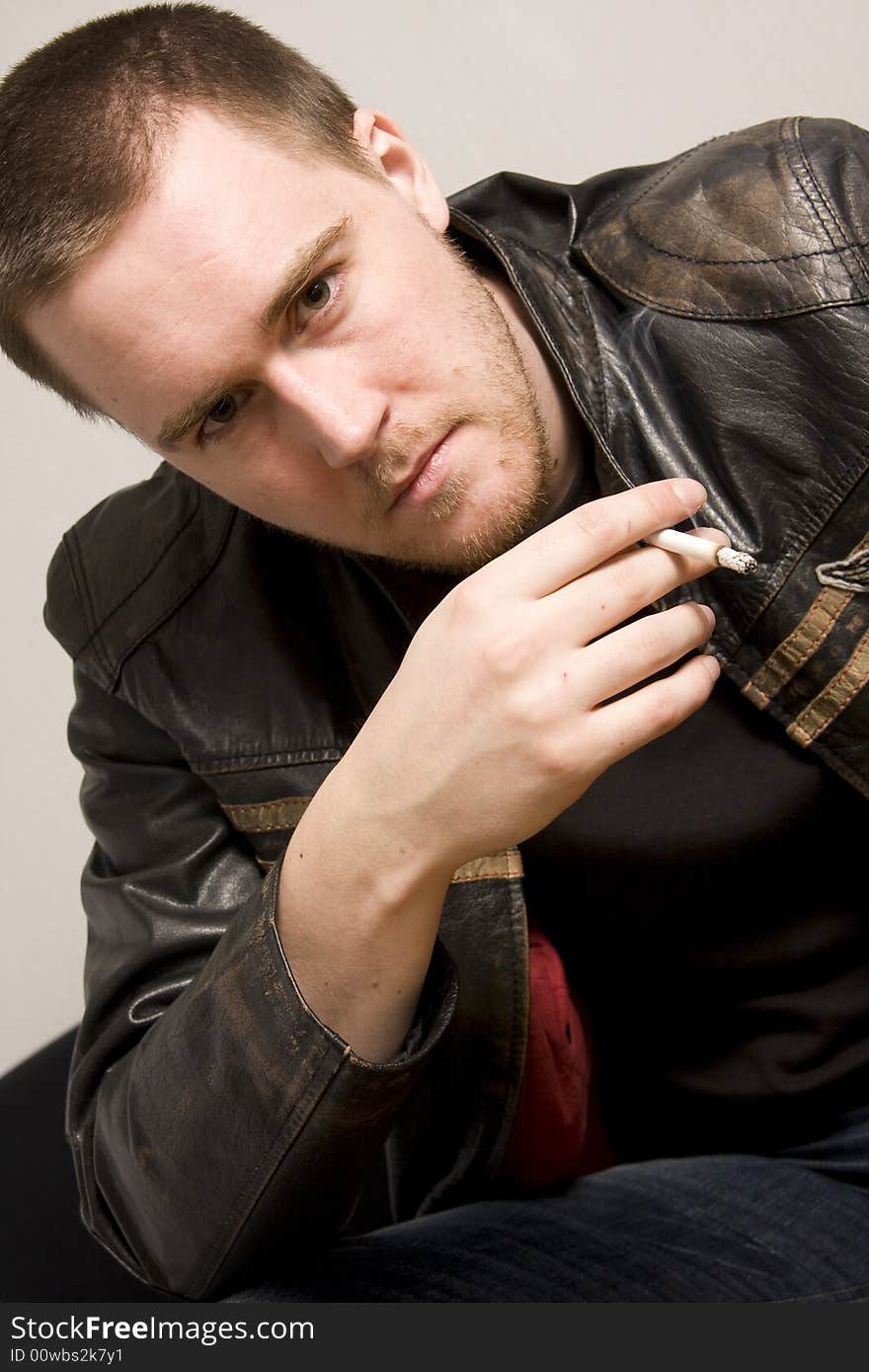 Portrait of young man smoking a cigarette