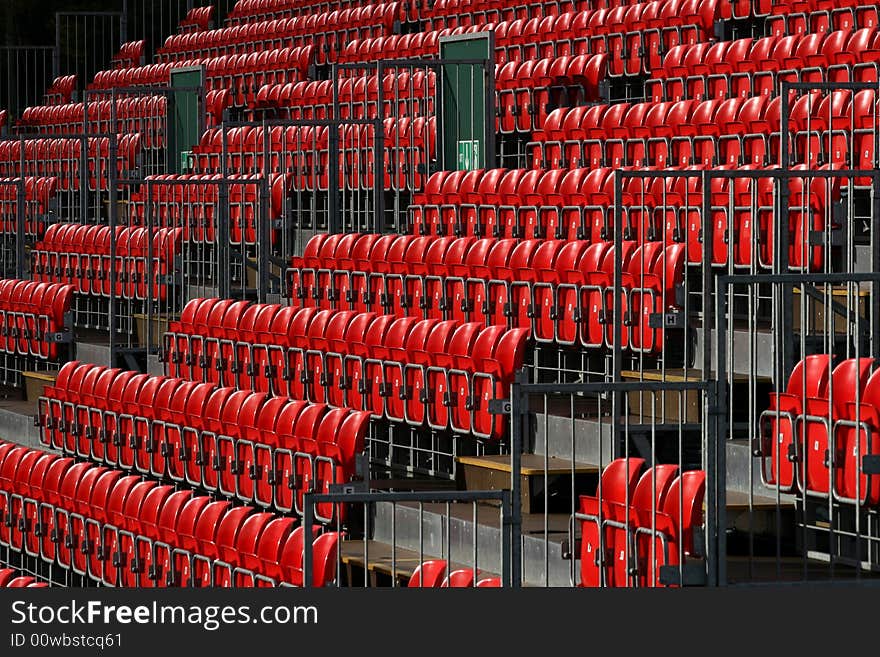 Empty red seats in sports stadium