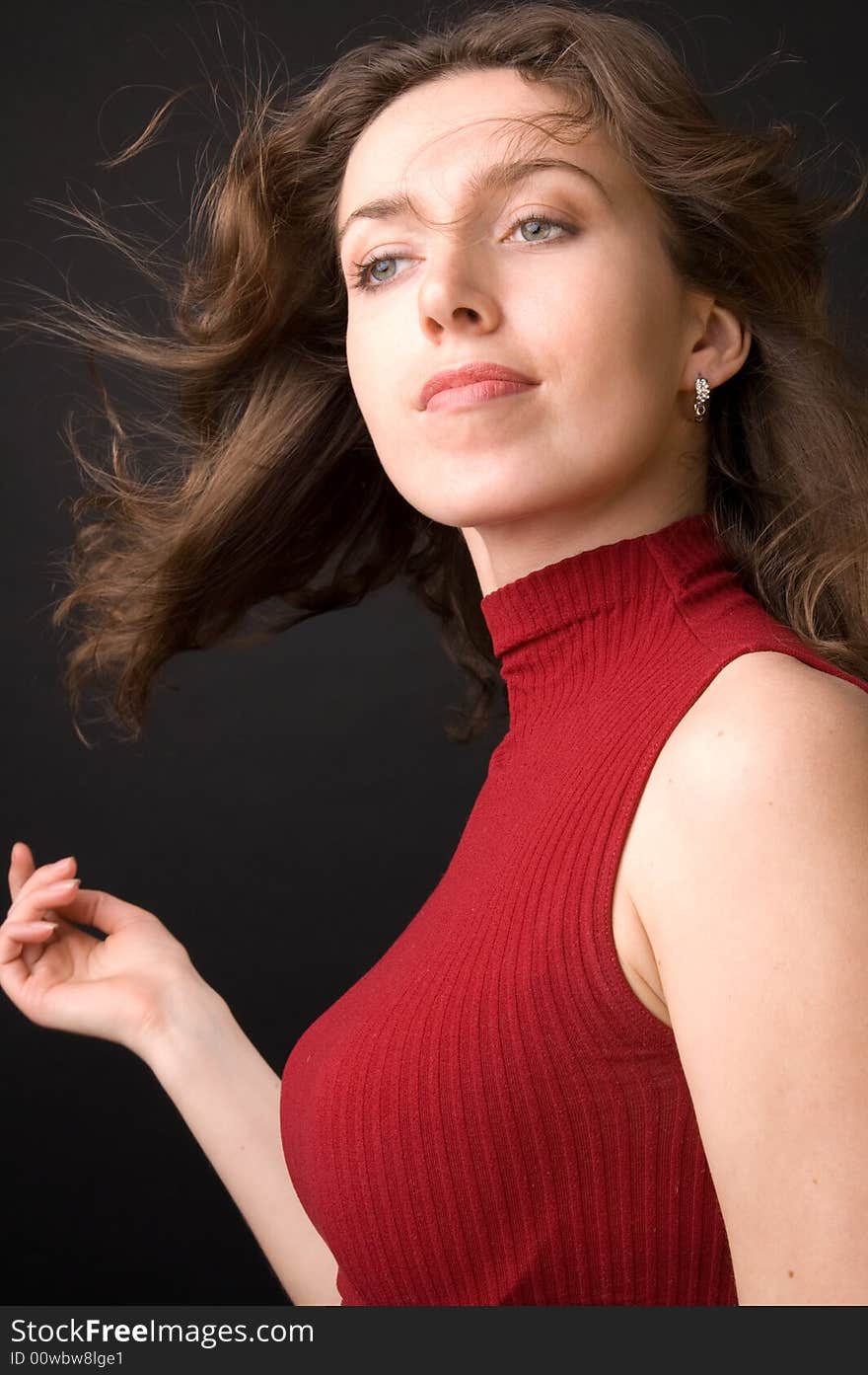 The beautiful girl in studio on a black background.