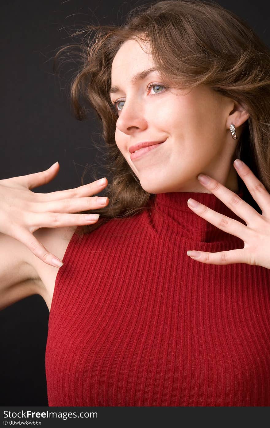 The beautiful girl in studio on a black background.