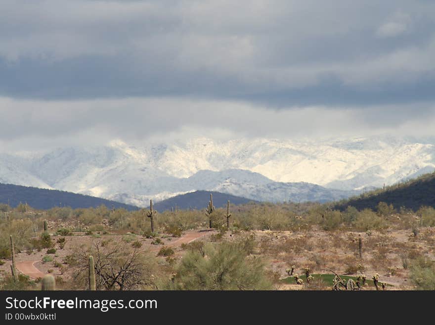 Snow covered mountain beyond the desert