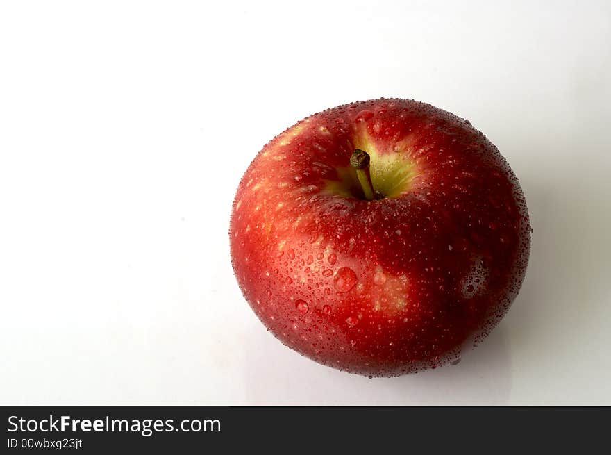 A wet apple over white background