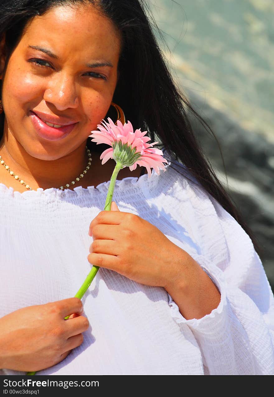 Woman Holding a Pink Daisy