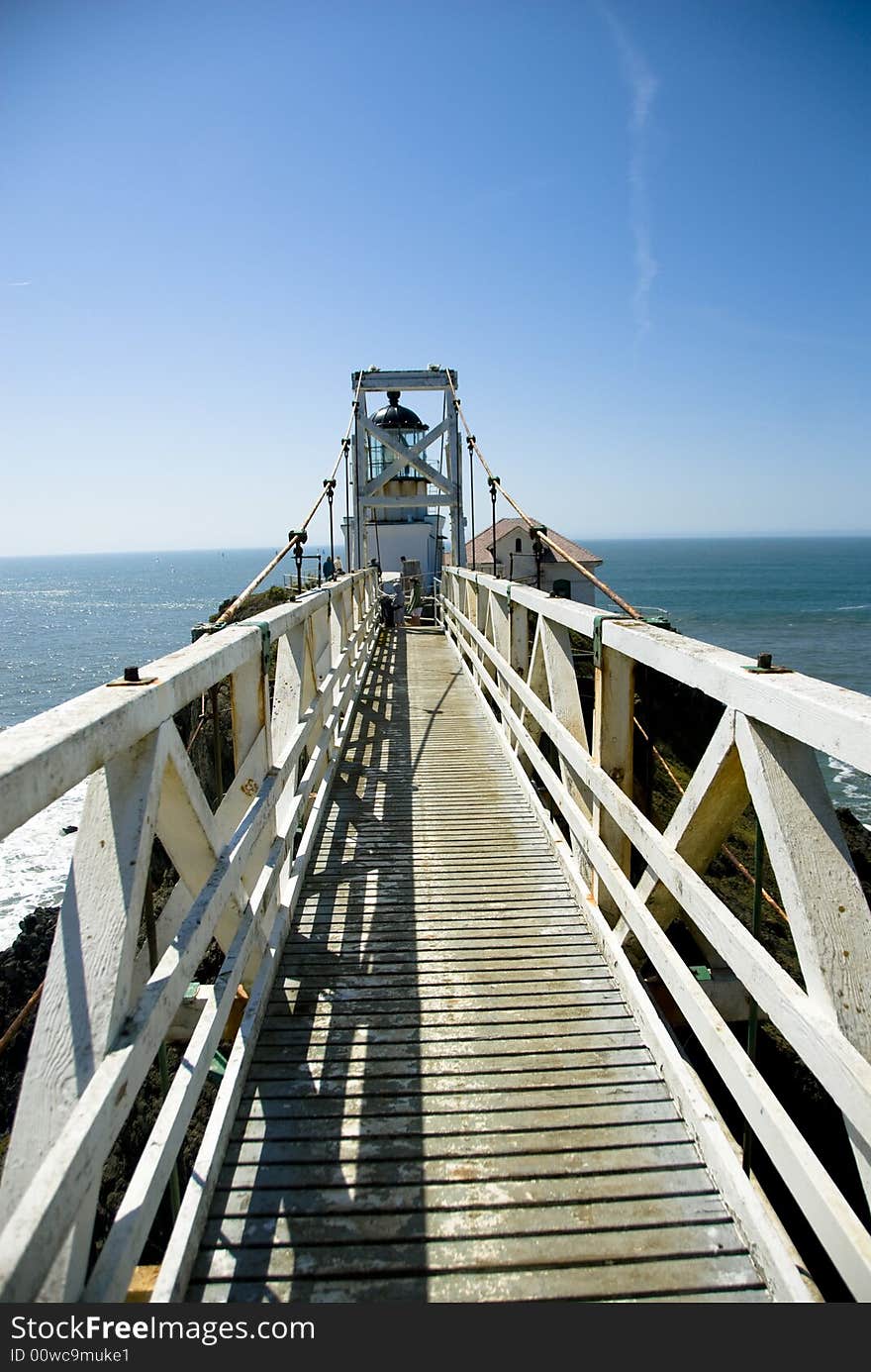 Picture of a bridge going to a light house