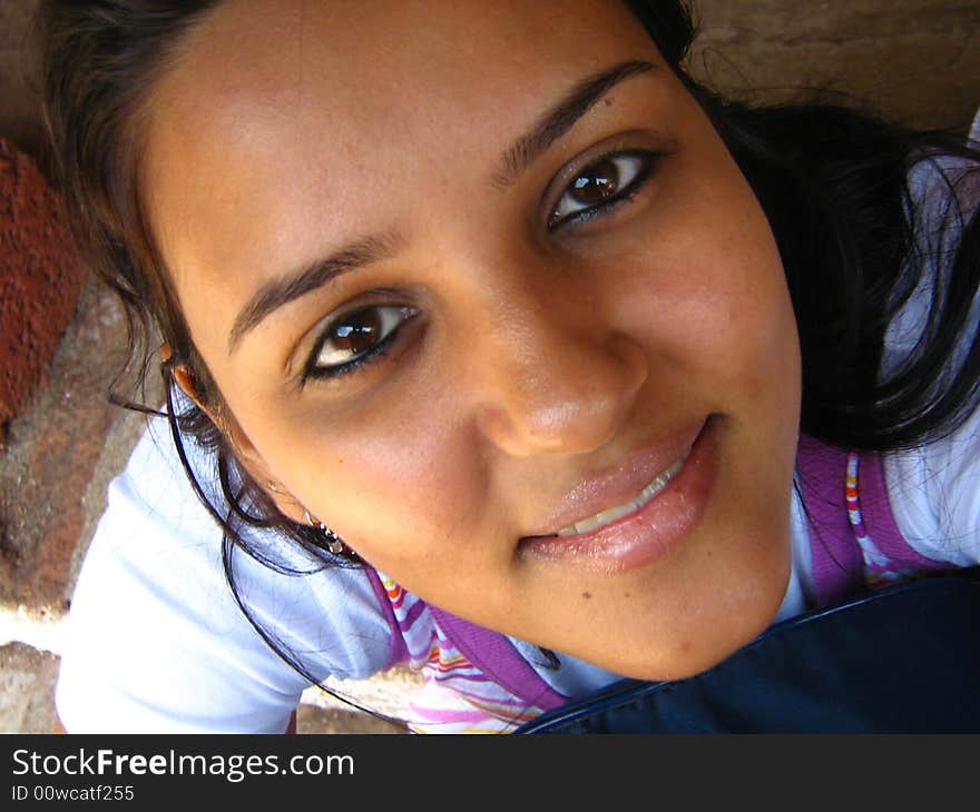 A girl smiling by facing towards the camera. A girl smiling by facing towards the camera