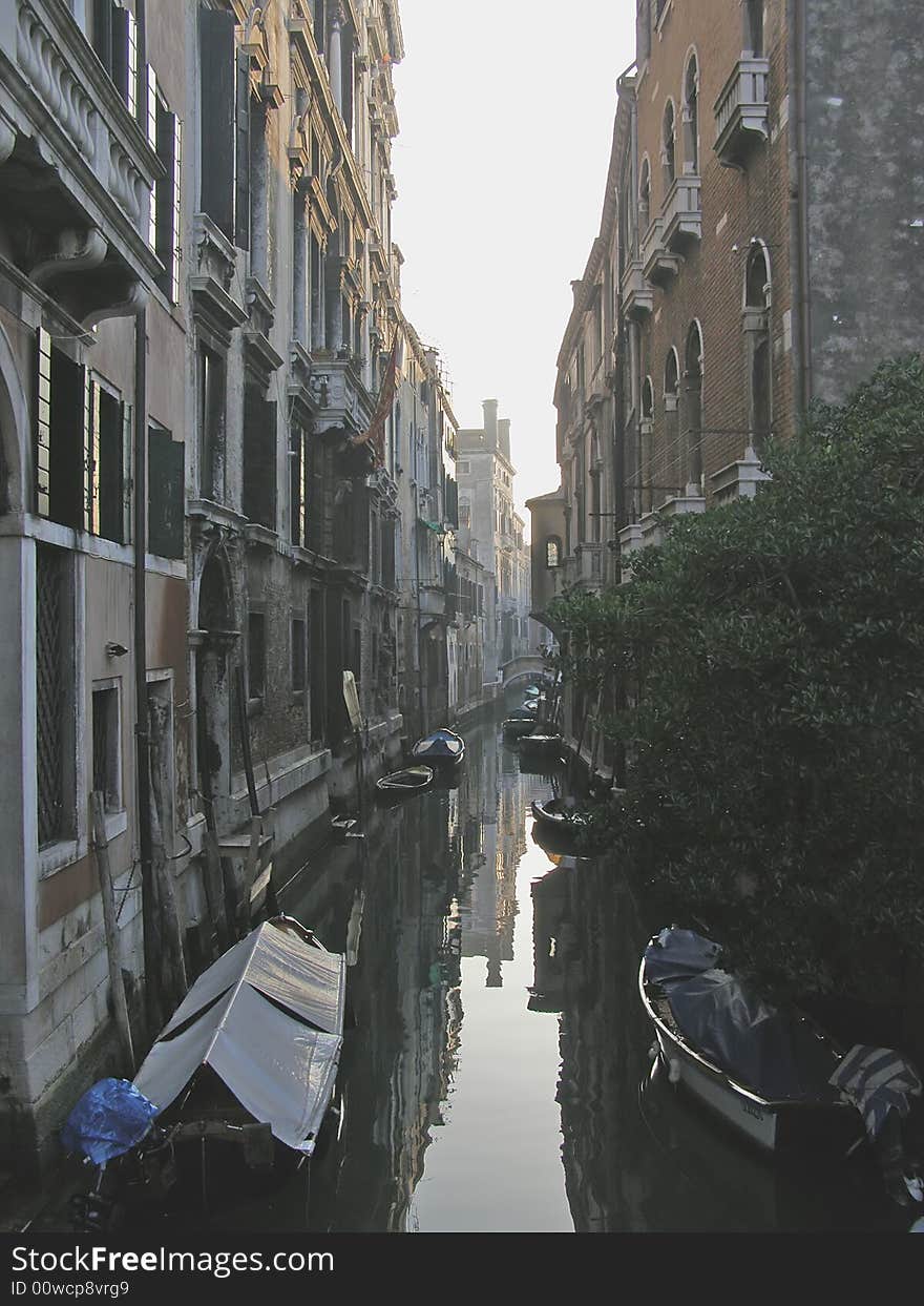 Venice (Italy) postcard: houses along a narrow back canal in Venice, dusk reflections. Venice (Italy) postcard: houses along a narrow back canal in Venice, dusk reflections