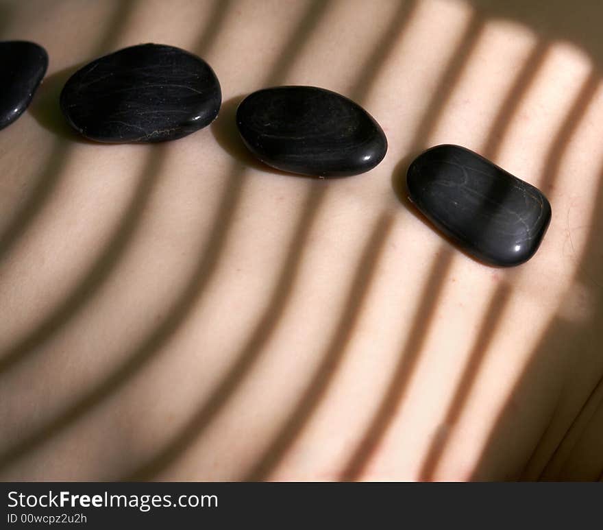 Three black stones for spa-massage on a back. Three black stones for spa-massage on a back