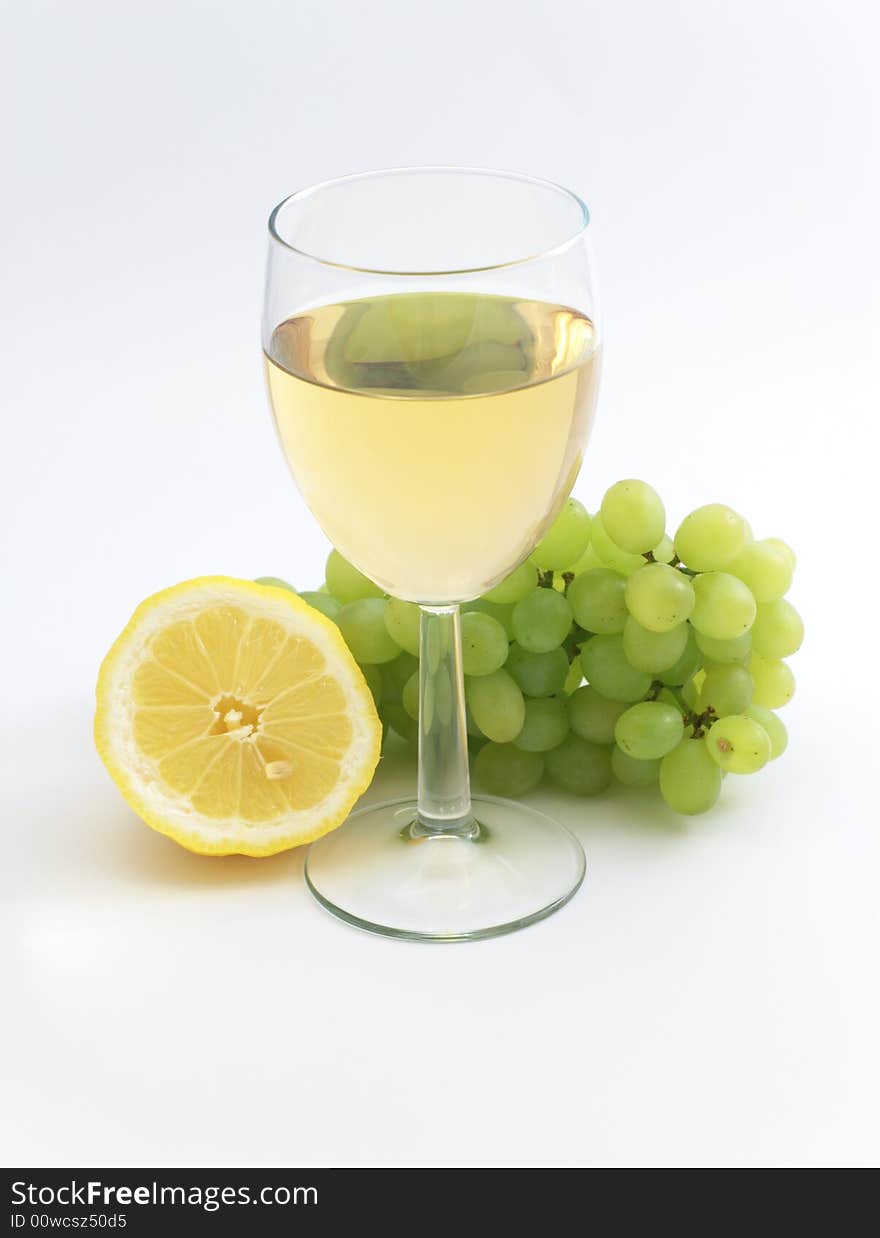 Wine, lemon and grape isolated on white background