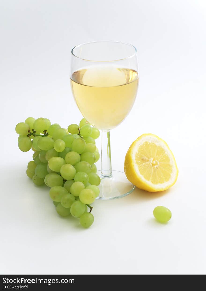 Wine, lemon and grape isolated on white background