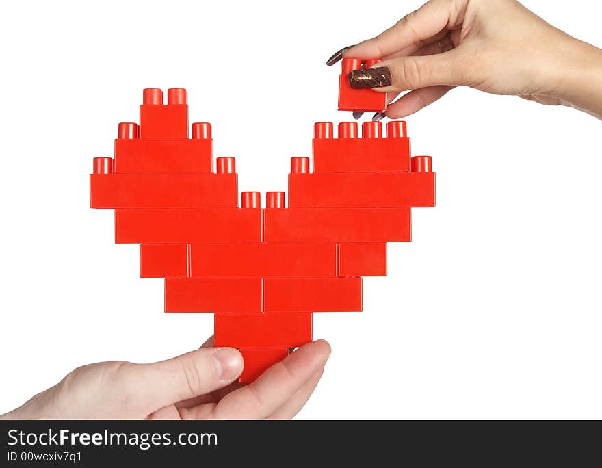 Hands building red heart isolated over white background