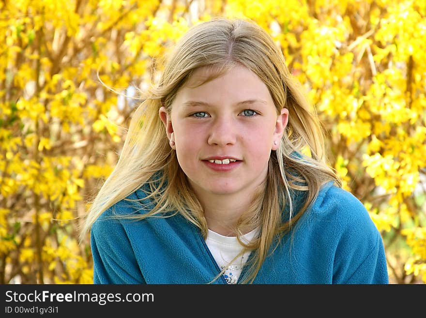 Beautiful blond girl with pretty flowers in the background. Beautiful blond girl with pretty flowers in the background.