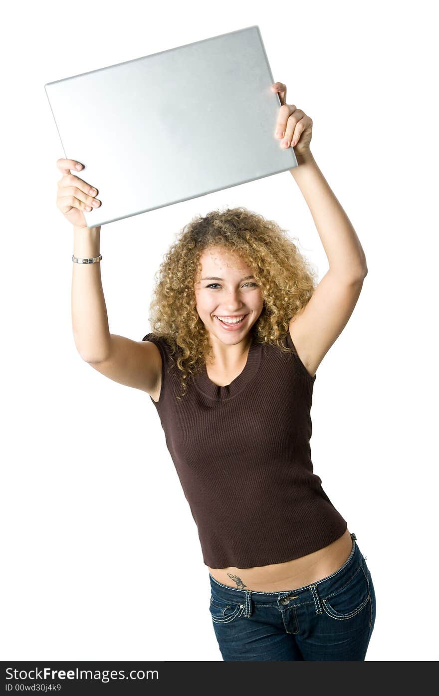 A beautiful young women holding her portable computer above her head. A beautiful young women holding her portable computer above her head