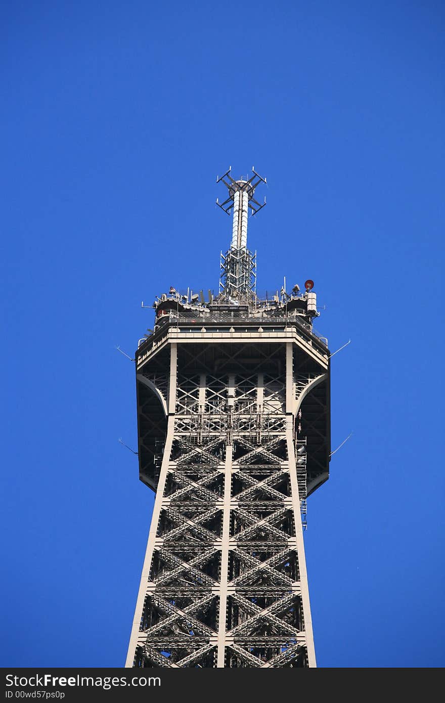 Details top of Eiffel Tower of Paris on a vey blue sky. Details top of Eiffel Tower of Paris on a vey blue sky