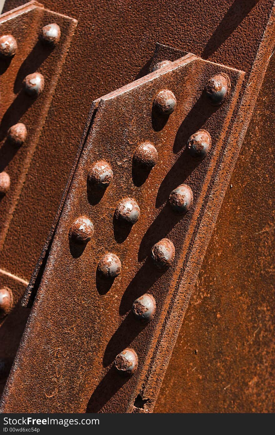 Structural details of a rusty steel cantilever bridge. Structural details of a rusty steel cantilever bridge.