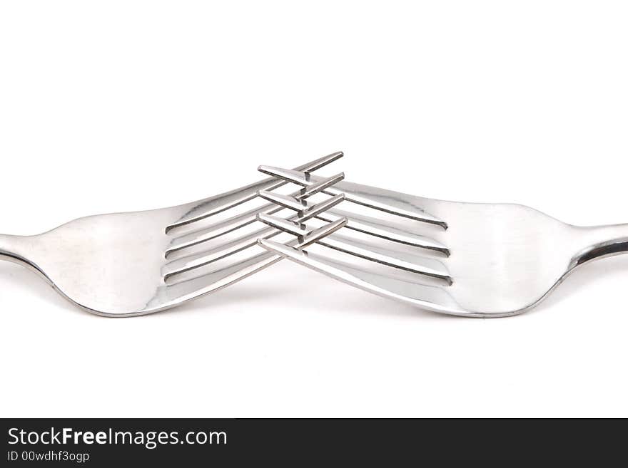 Two stainless steel forks on a white background. Two stainless steel forks on a white background.