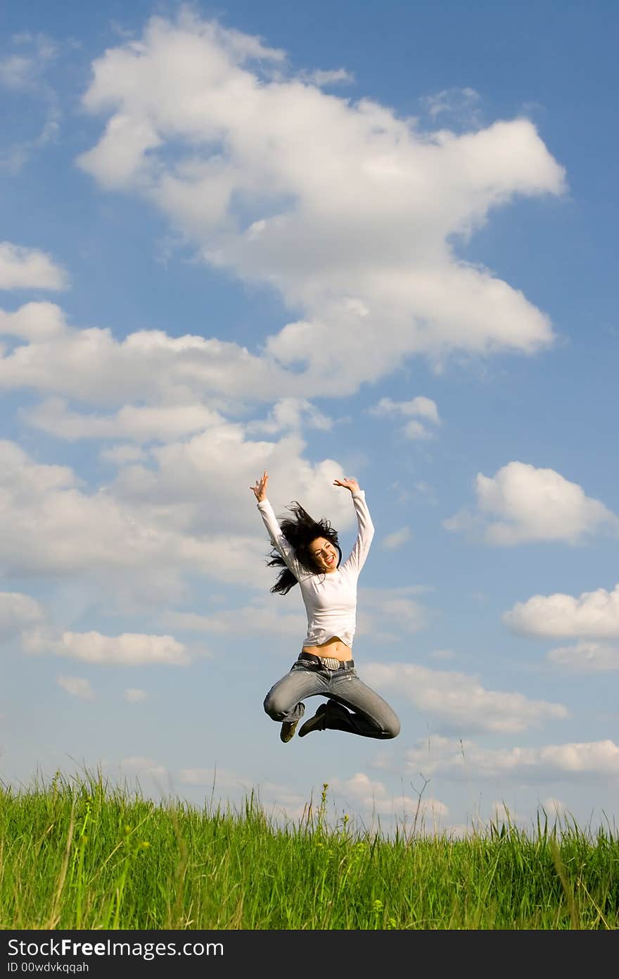 Happy young woman is jumping