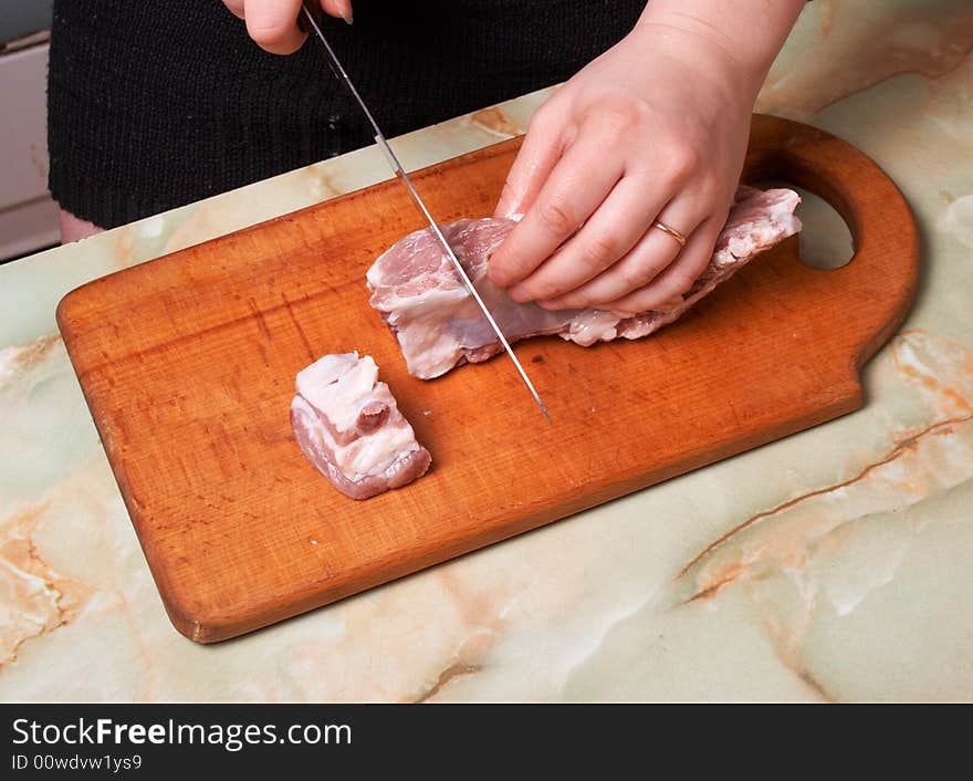 Cutting meat, bald-rib on wooden board. Cutting meat, bald-rib on wooden board.