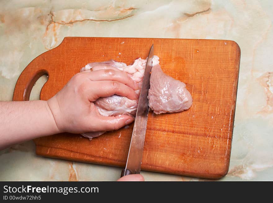 Cutting meat, bald-rib on wooden board. Cutting meat, bald-rib on wooden board.