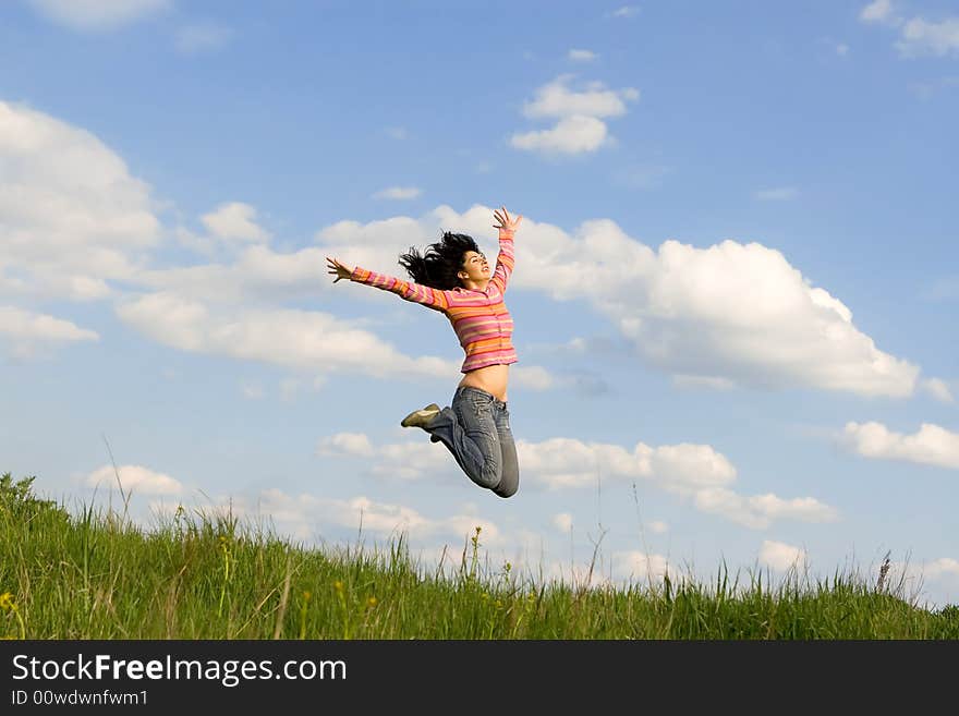 Happy young woman is jumping