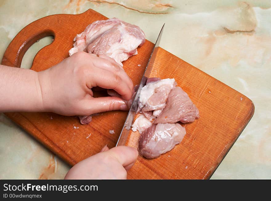 Cutting meat, bald-rib on wooden board. Cutting meat, bald-rib on wooden board.