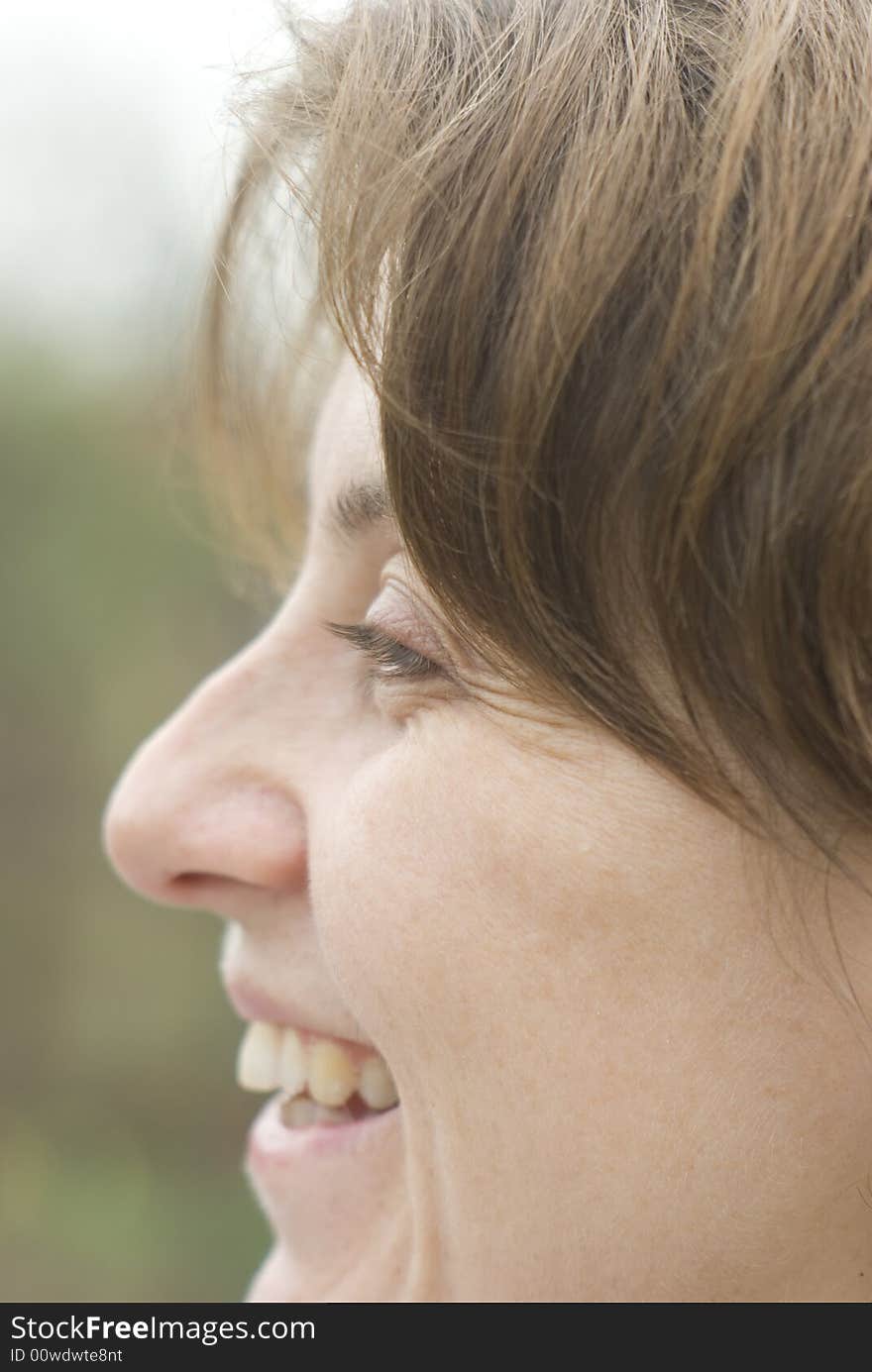 Laughing young woman on the nature background. Laughing young woman on the nature background.