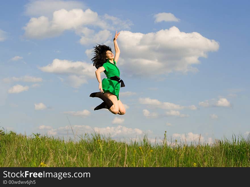 Happy young woman is jumping