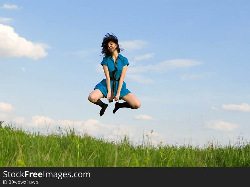 Happy young woman is jumping