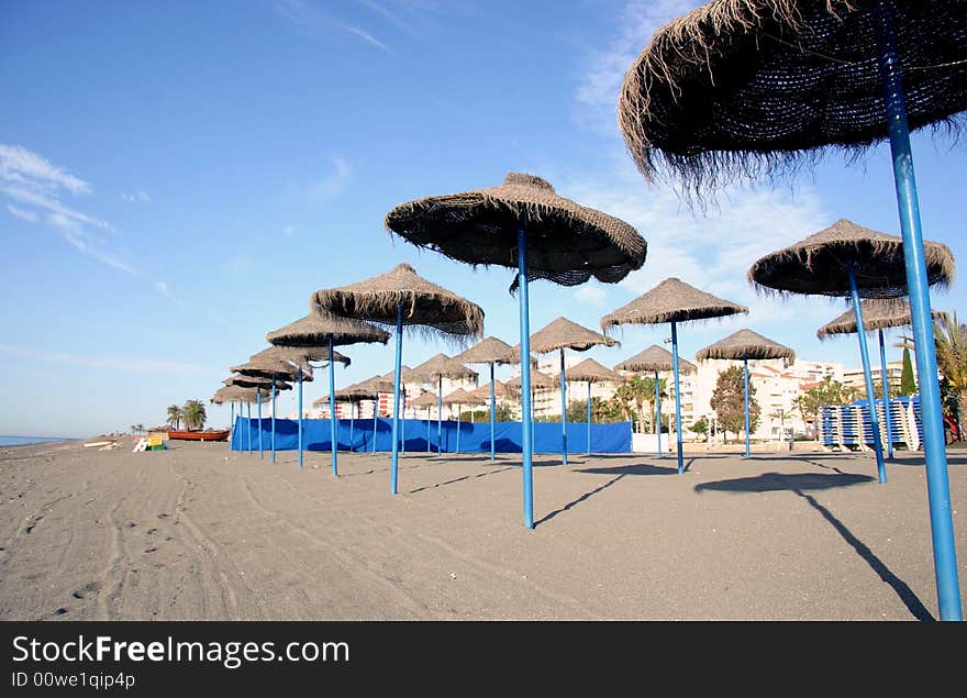 Overview of a beach with thatched umbrellas