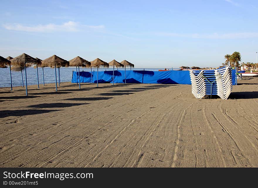 Overview of a beach with thatched umbrellas