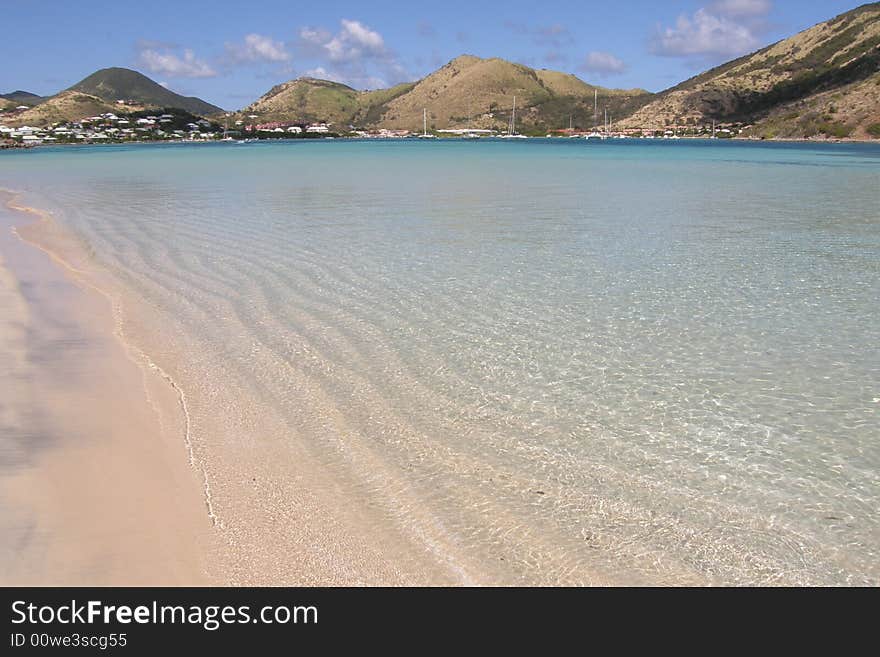 Shallow beach overlooking hills and village. Shallow beach overlooking hills and village