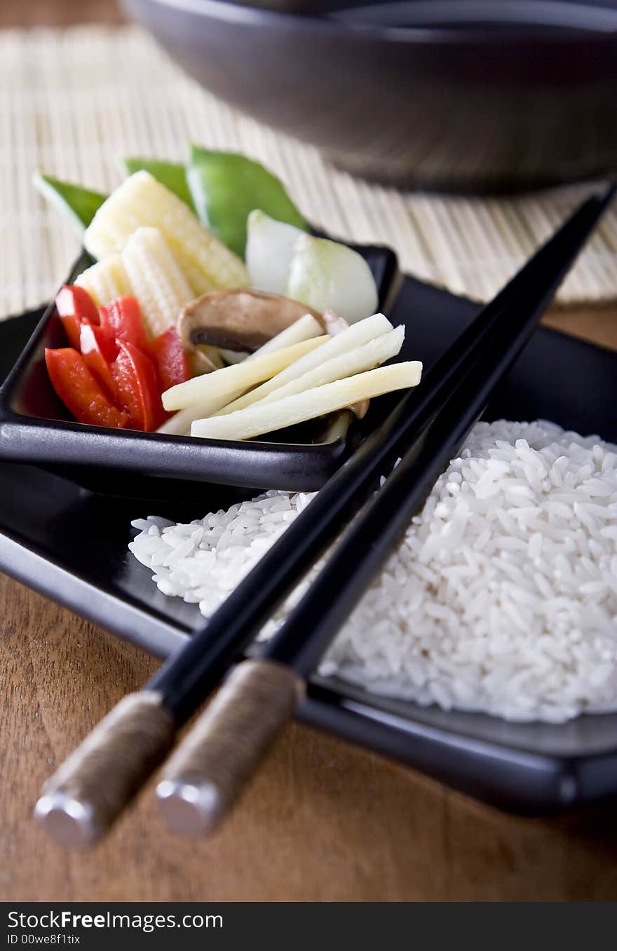 Rice and Vegtables on a plate with chopsticks. A health meal. Rice and Vegtables on a plate with chopsticks. A health meal.