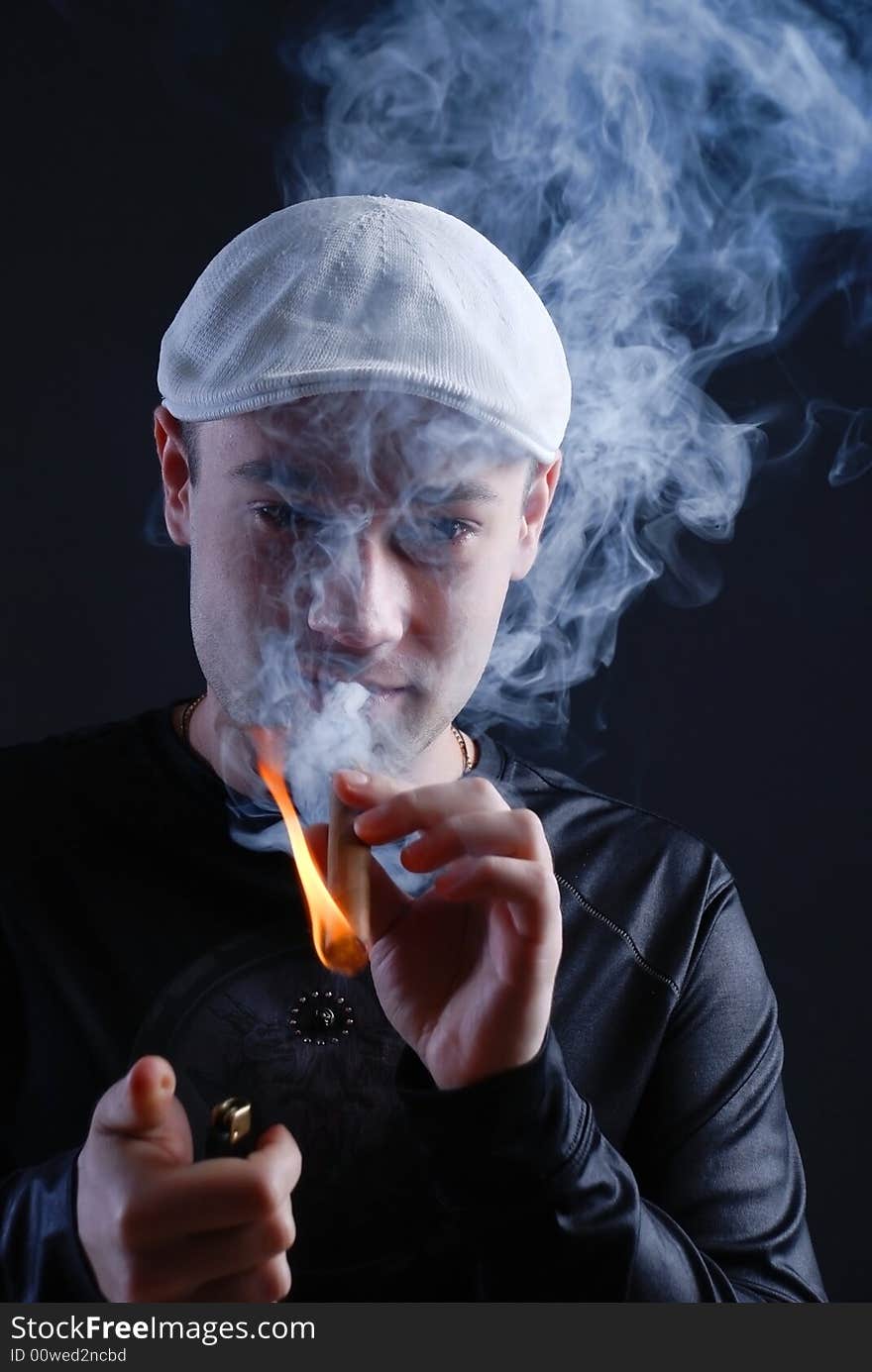 Man with cigare at black background