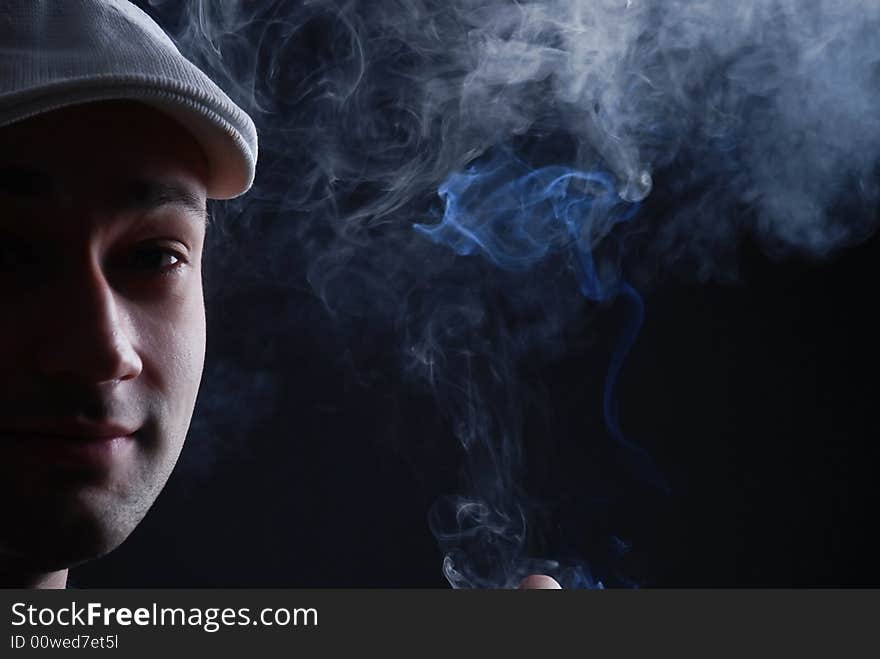 Man with cigare at black background