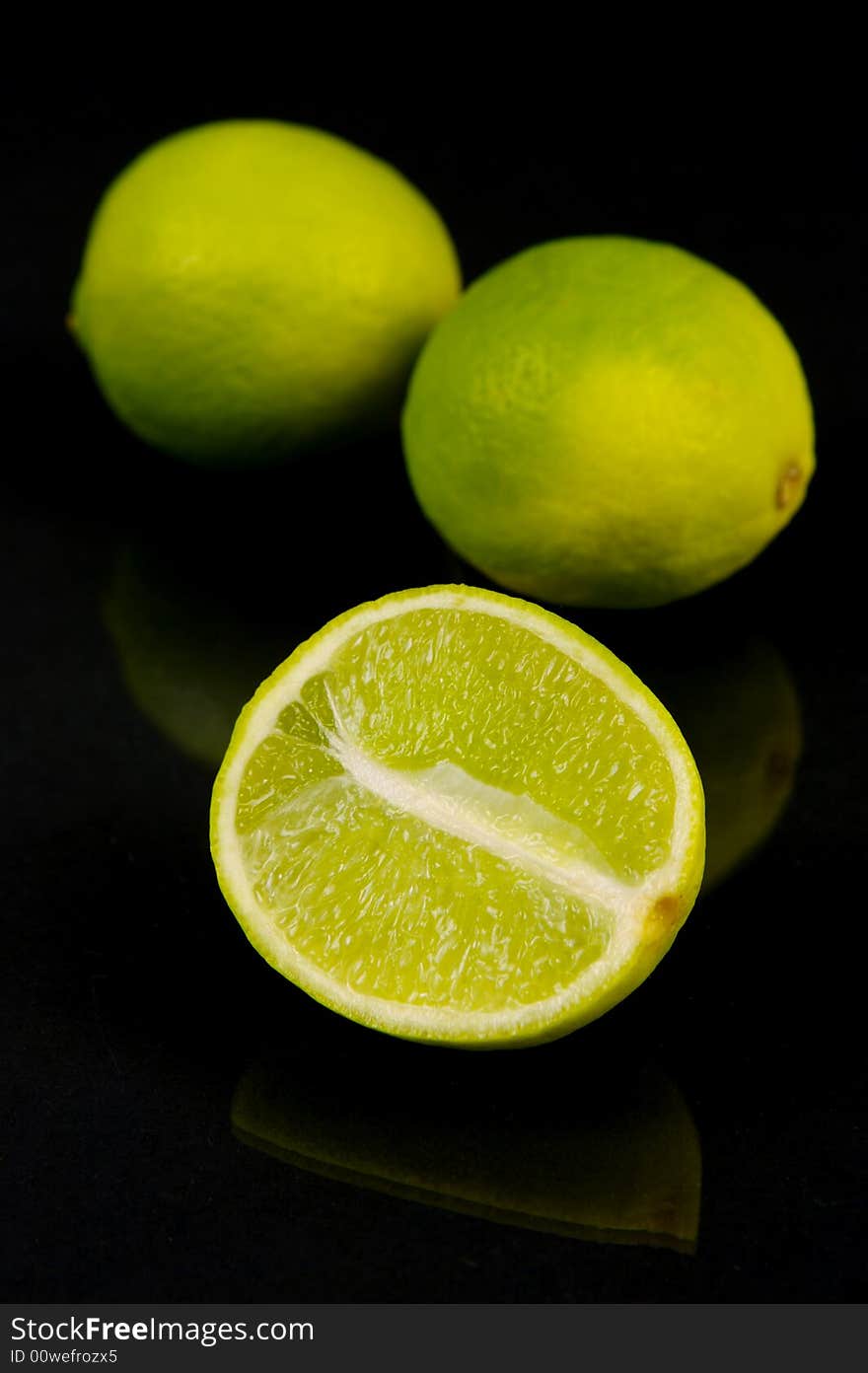 Lemon and lime fruit isolated against a black background. Lemon and lime fruit isolated against a black background