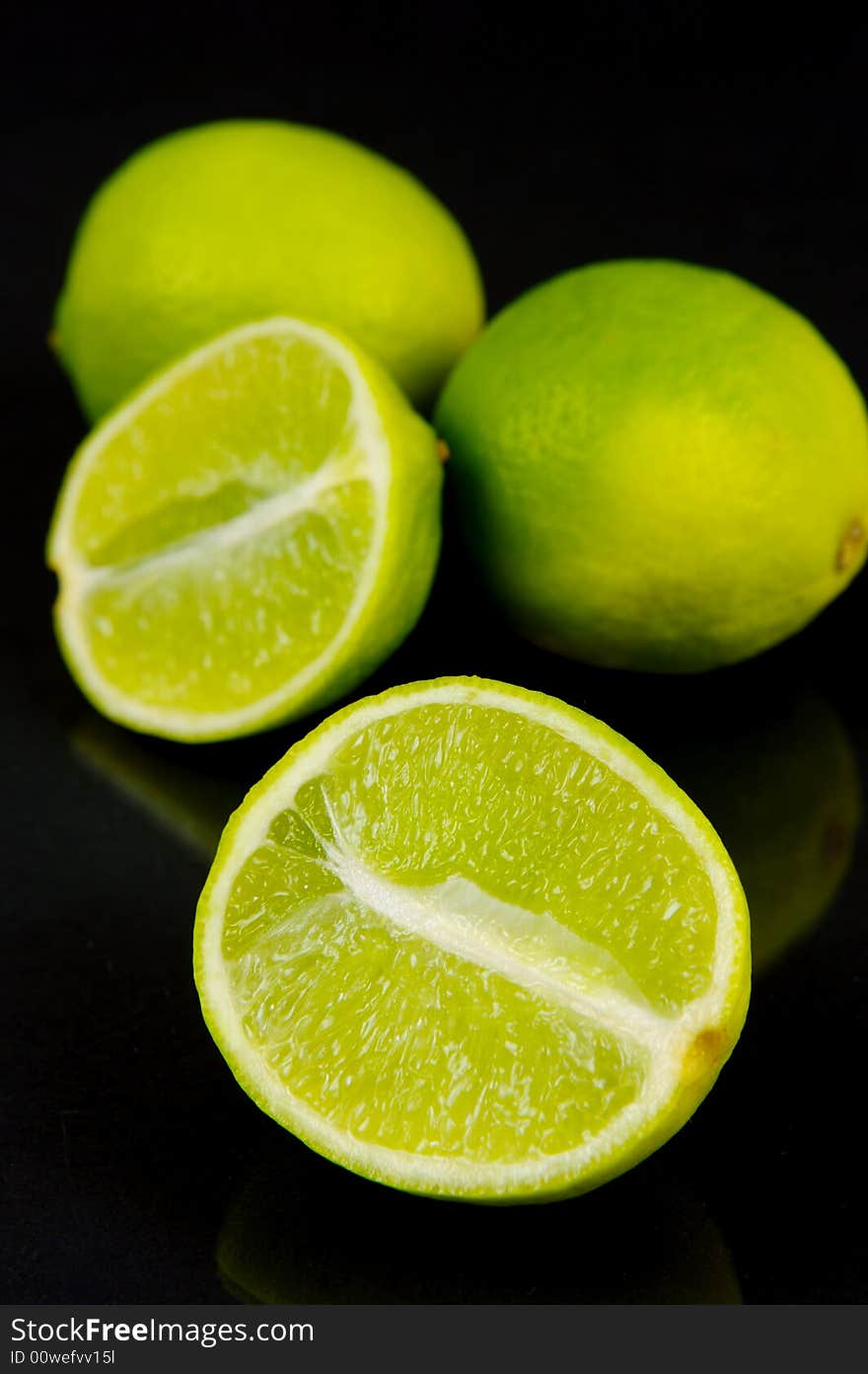 Lemon and lime fruit isolated against a black background. Lemon and lime fruit isolated against a black background