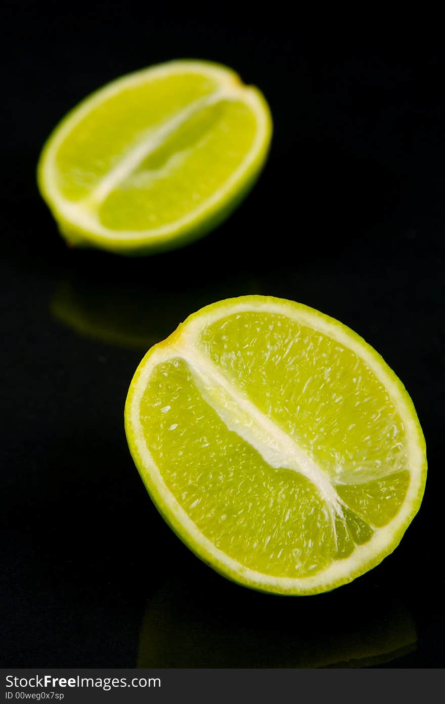 Lemon and lime fruit isolated against a black background. Lemon and lime fruit isolated against a black background