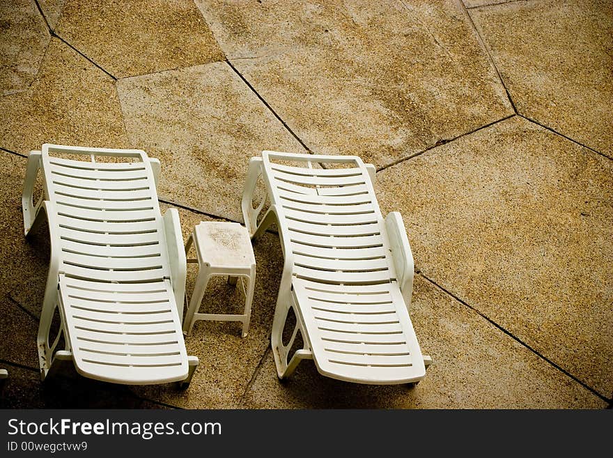 Empty white pool chairs waiting for tourists. Empty white pool chairs waiting for tourists