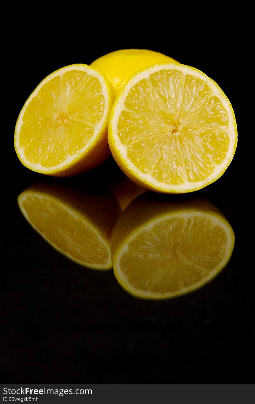 Lemon and lime fruit isolated against a black background. Lemon and lime fruit isolated against a black background