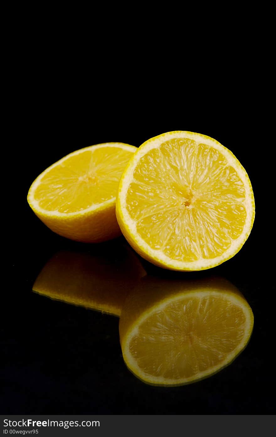 Lemon and lime fruit isolated against a black background. Lemon and lime fruit isolated against a black background