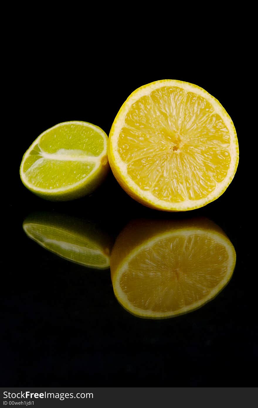 Lemon and lime fruit isolated against a black background. Lemon and lime fruit isolated against a black background