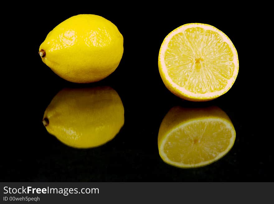 Lemon and lime fruit isolated against a black background. Lemon and lime fruit isolated against a black background