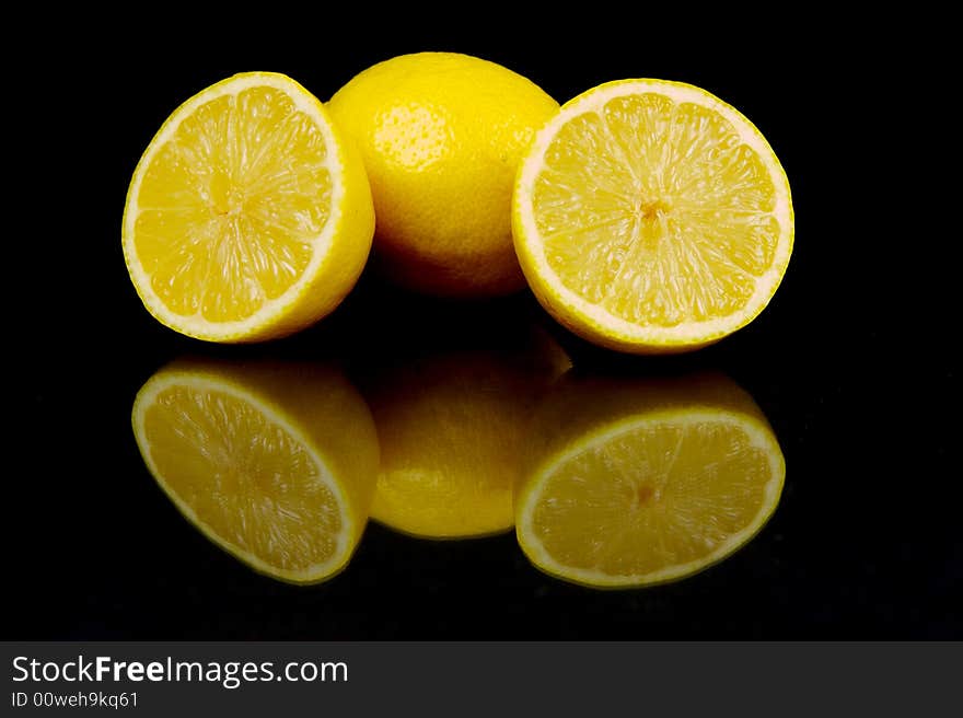 Lemon and lime fruit isolated against a black background. Lemon and lime fruit isolated against a black background