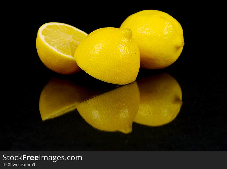 Lemon and lime fruit isolated against a black background. Lemon and lime fruit isolated against a black background