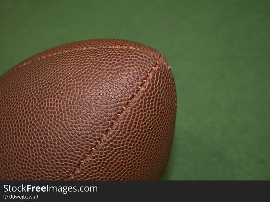 Football in close up and a green background