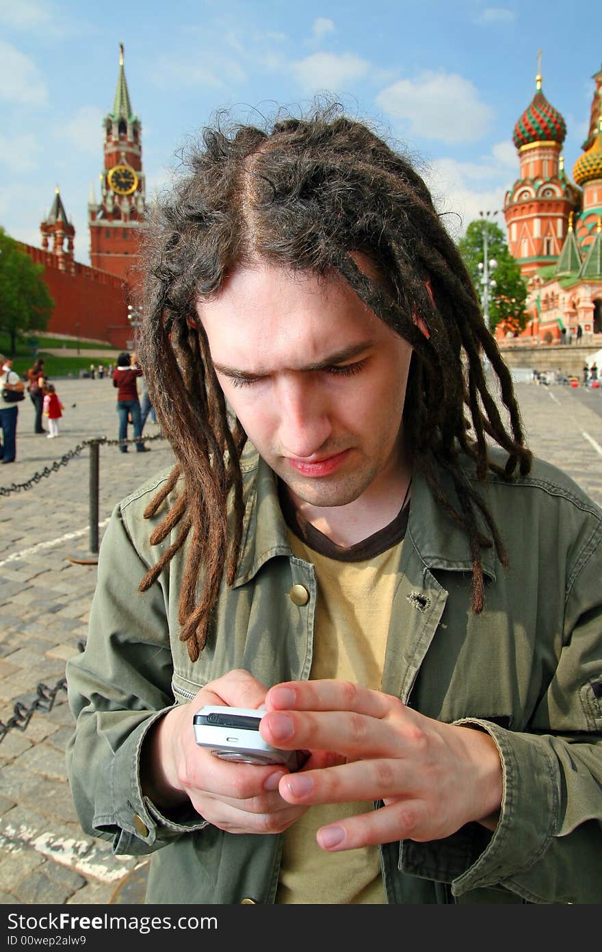 Young man with dreadlock hair and mobile phone. Young man with dreadlock hair and mobile phone.