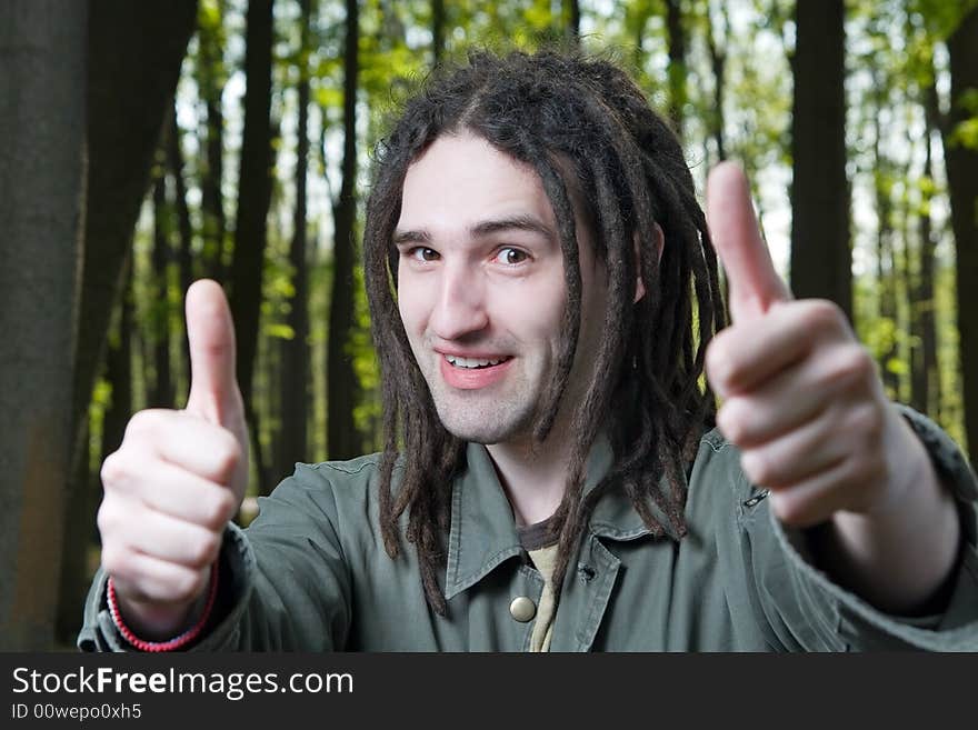 Young man with dreadlock hair gesticulates hands. Young man with dreadlock hair gesticulates hands.