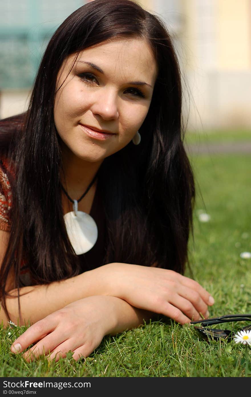 Attractive brunette woman on green grass. Attractive brunette woman on green grass