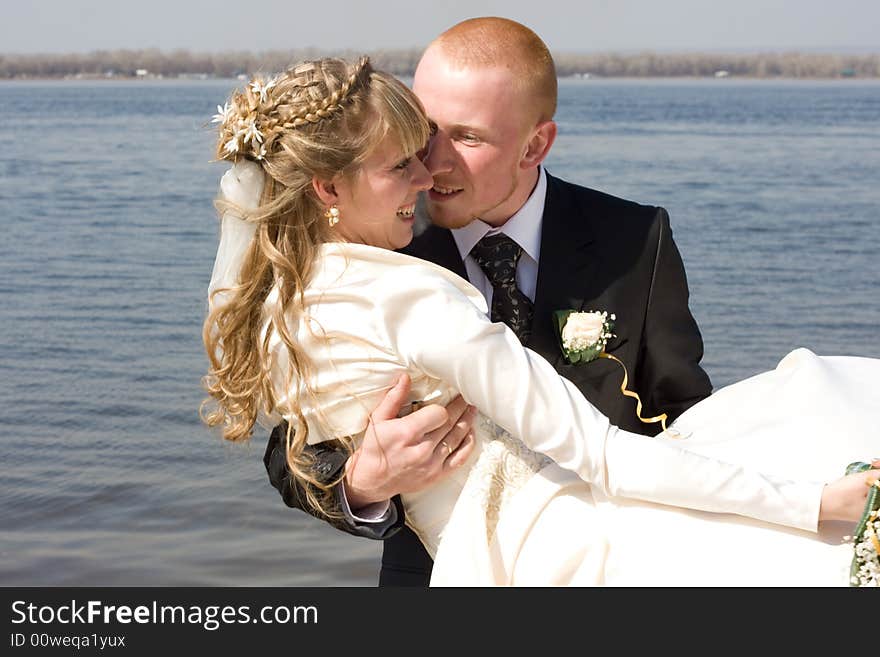 Happy bride and groom at the river