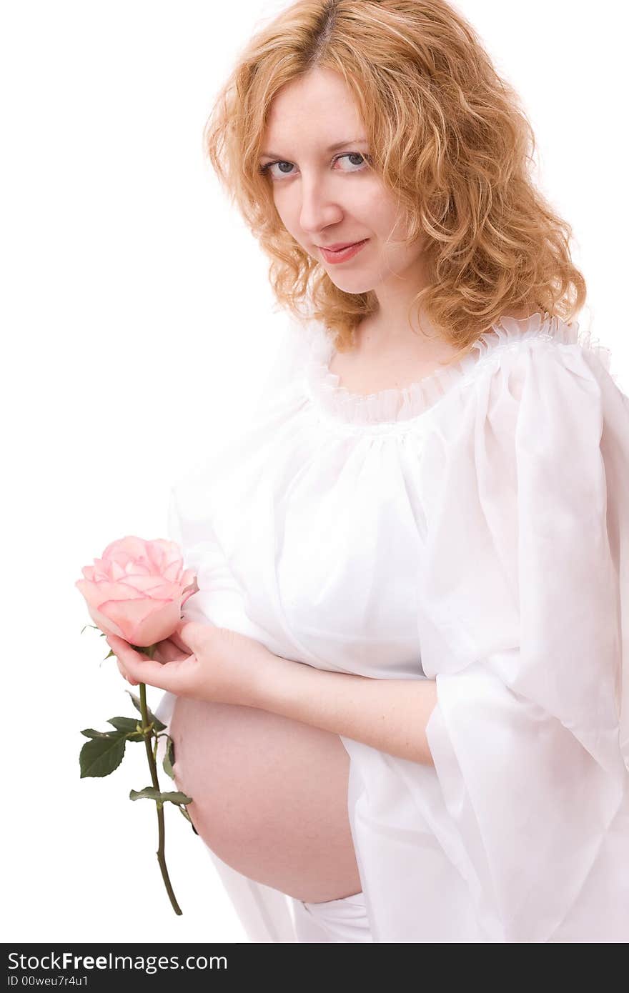 Romantic image of beautiful pregnant woman with rose in her hand over white