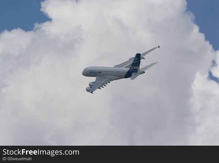 Jet airplane in the clouds and sun